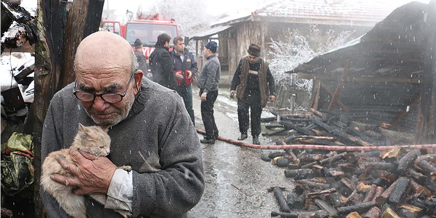 Kedisine sarılıp evinin yanışını izledi